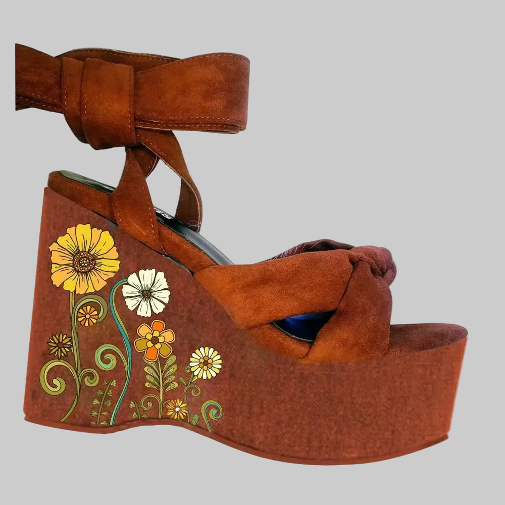 Printed platform wedge sandals with lace-up closure and floral motif on the wedge base
