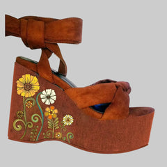 Printed platform wedge sandals with lace-up closure and floral motif on the wedge base