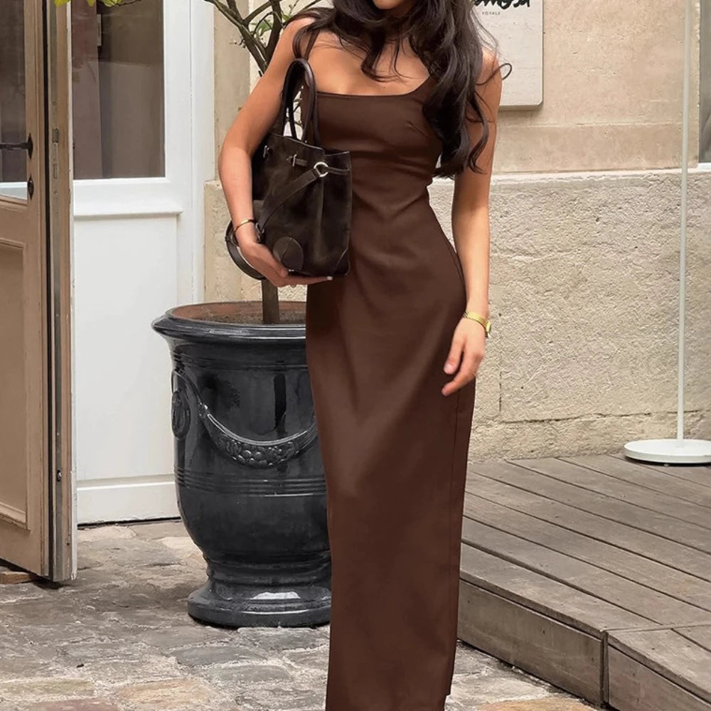 Brown square neck maxi dress styled with matching handbag outdoors