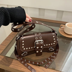 Hand-held angle showing the bag’s curved silhouette and reinforced corners, styled as an underarm carry for a sharp, modern look.