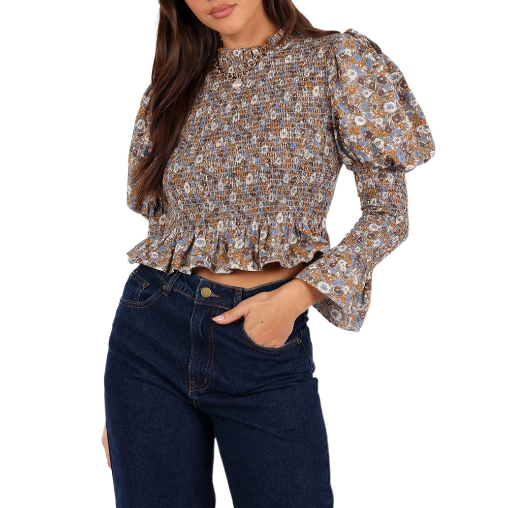 Close-up of bubble sleeves and round neckline on floral blouse
