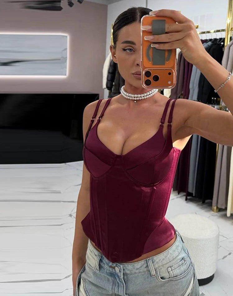 Close view highlighting the structured bust seams and smooth satin finish on a burgundy boned corset tank top.