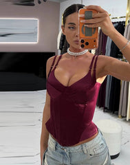 Close view highlighting the structured bust seams and smooth satin finish on a burgundy boned corset tank top.