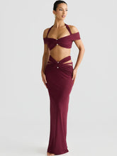 model wearing a burgundy halter cutout two piece set in studio