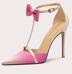 A close-up of the butterfly knot and heel detail on the shoe.