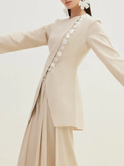 A close-up of the button closure detail on the jacket.