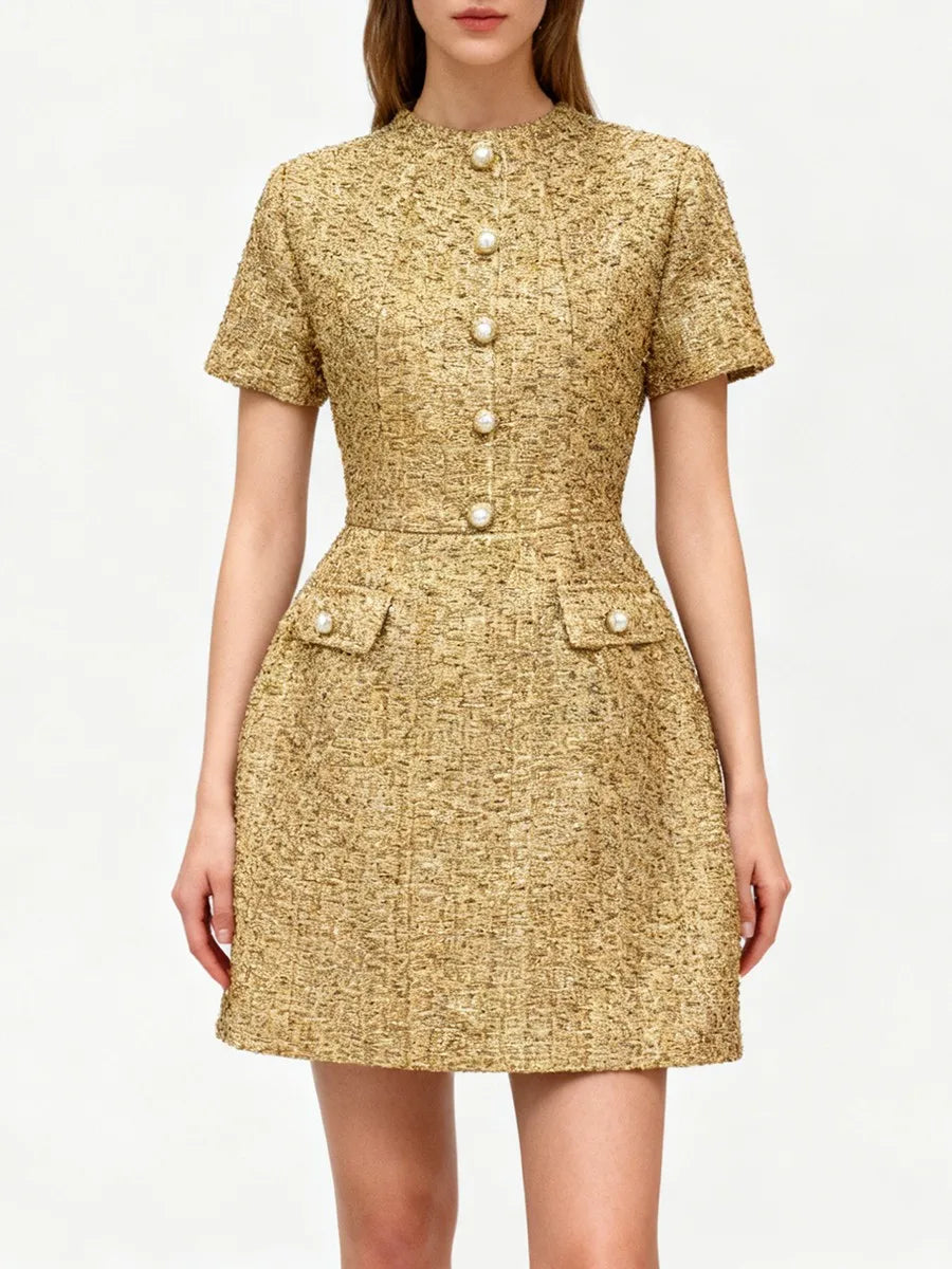 A tailored mini dress with button trim and short sleeves styled for refined daytime wear.