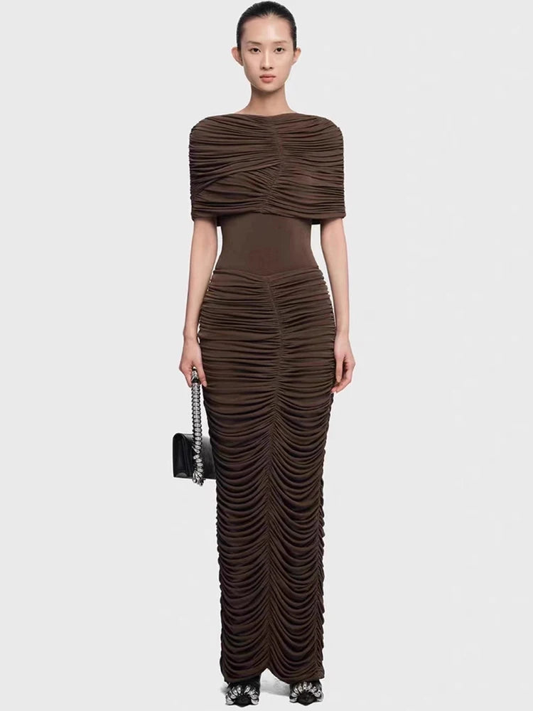 Upper-body focus showing the cape overlay drape across the shoulders and the clean high neckline, styled with minimal jewelry.