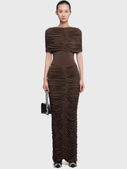 Upper-body focus showing the cape overlay drape across the shoulders and the clean high neckline, styled with minimal jewelry.
