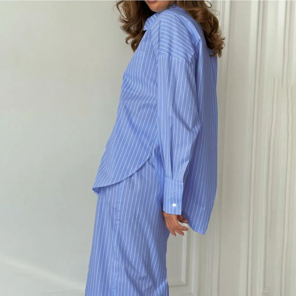 Person wearing a relaxed office co-ord in breathable cotton blend against a white wall.