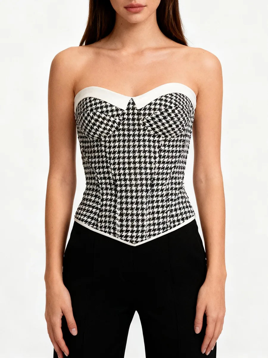 Lifestyle styling of a gingham corset top paired with trousers, highlighting its tailored waist shaping and lightweight woven finish.
