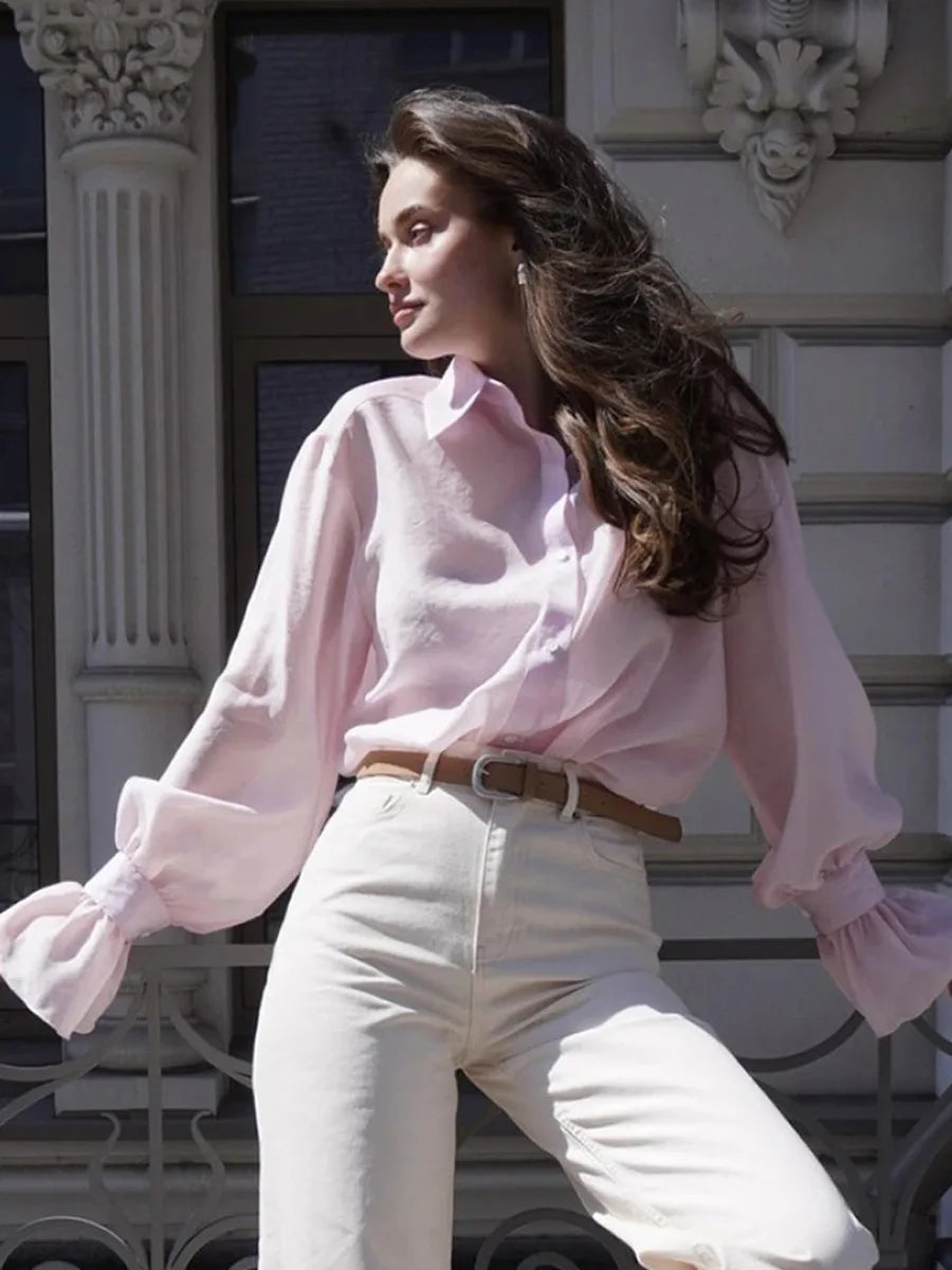 Button-up pink shirt styled casually with feminine flair