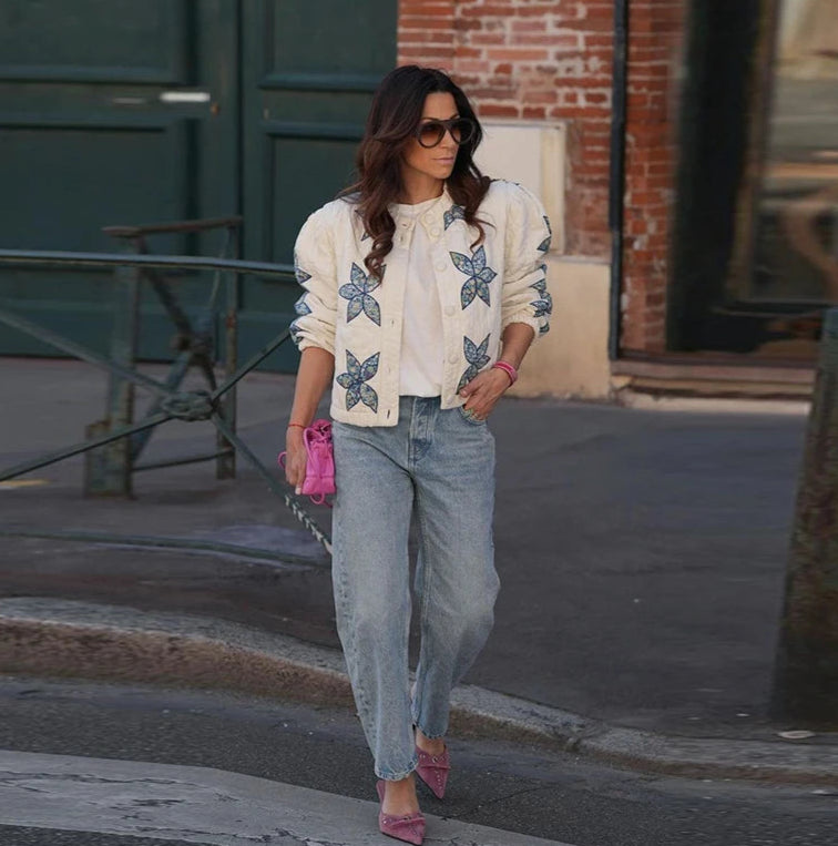 The jacket styled with jeans for a comfortable and chic winter streetwear look.