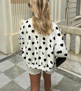 The jacket styled with jeans for a comfortable and chic winter streetwear look.