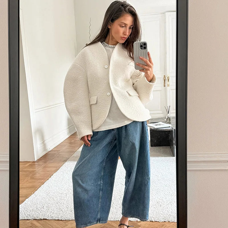 The jacket styled with jeans for a comfortable and chic winter streetwear look.