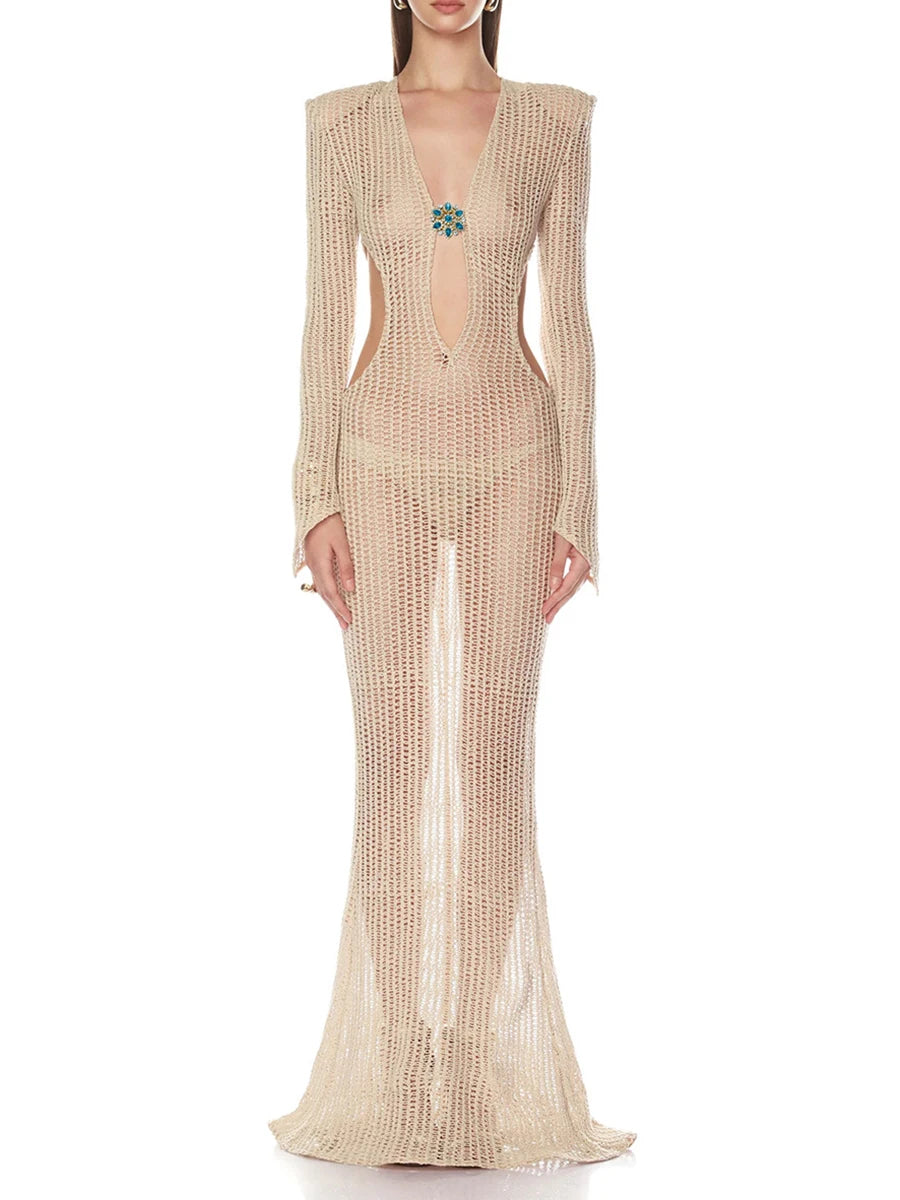 Full-length champagne openwork knit maxi dress with long sleeves and deep V neckline, finished with a central jewel detail.