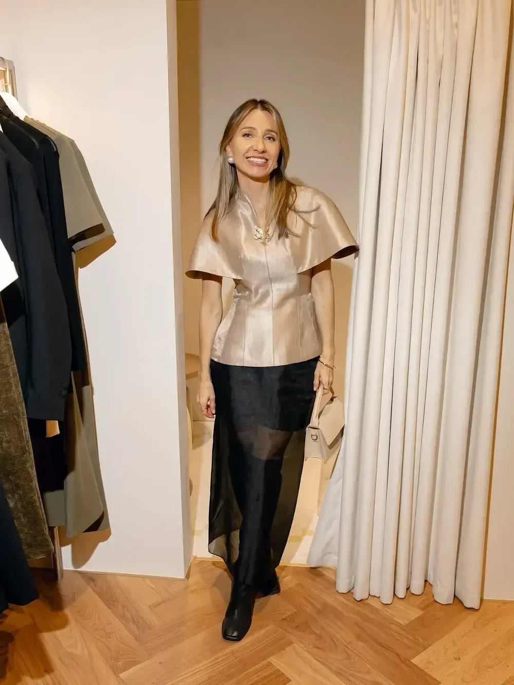 Structured cape-sleeve top styled with wide-leg trousers