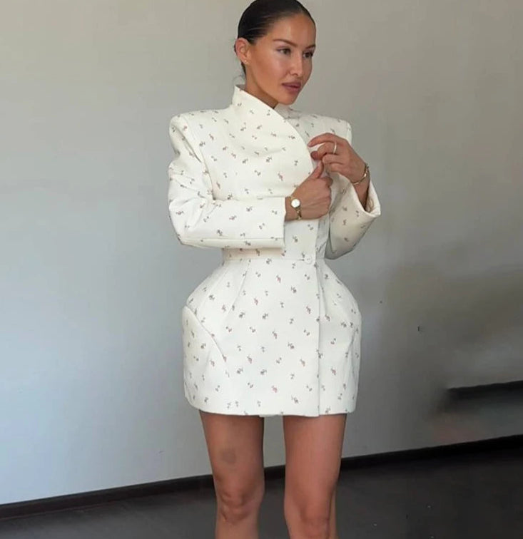 A close-up shot of the elegant floral pattern and the single-breasted closure.