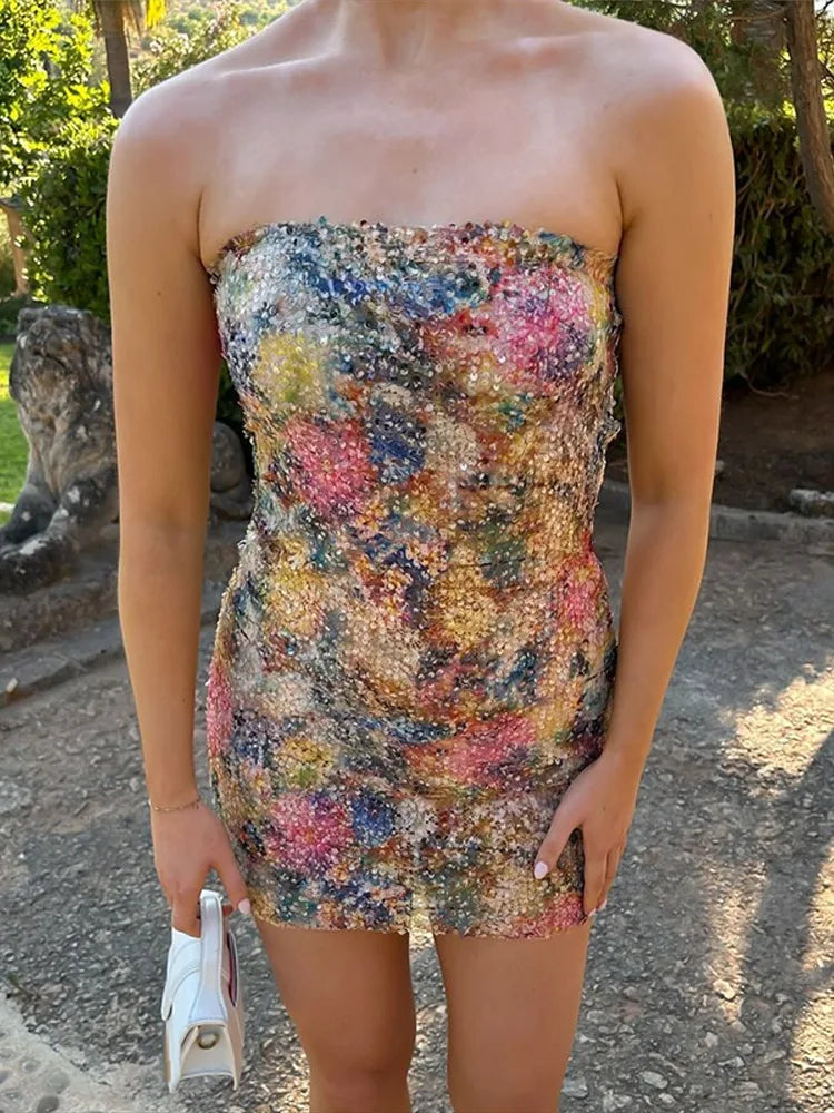 close view of color-splashed sequin strapless bodice