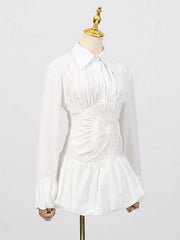 Cinched-waist white mini dress paired with minimal accessories on a mannequin against a white background