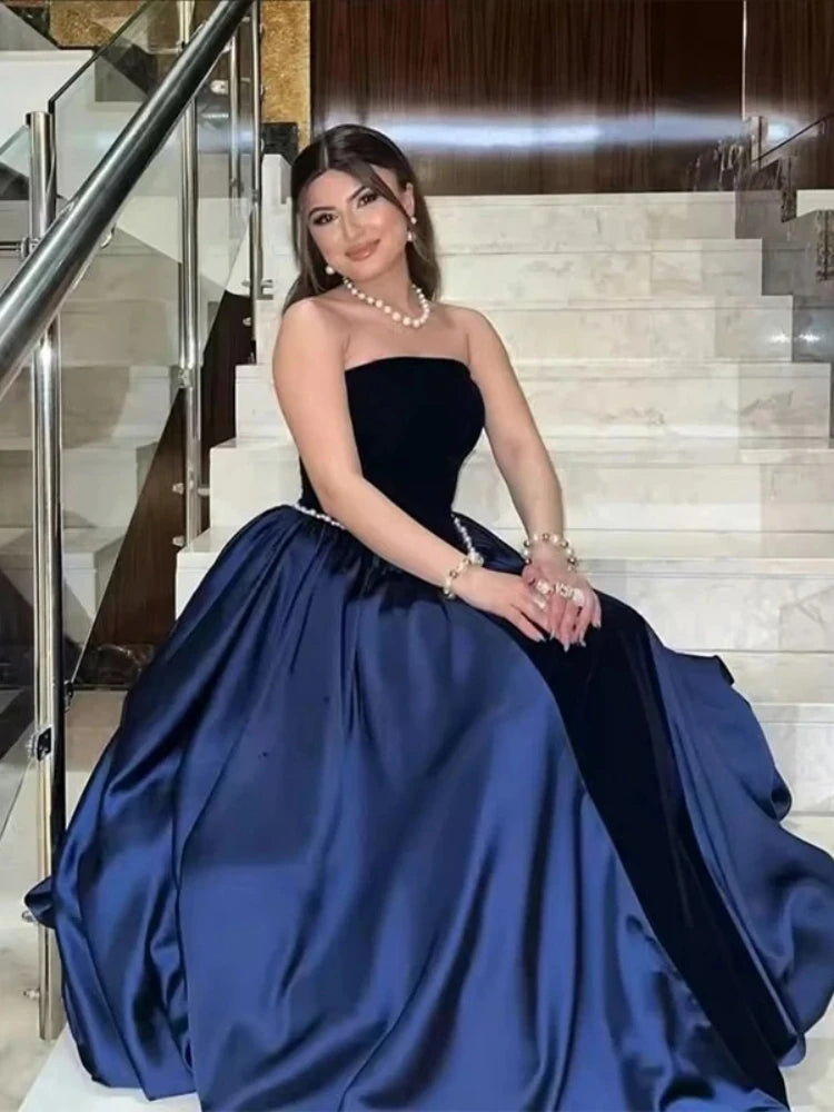 Elegant lifestyle shot of a velvet strapless gown styled for outdoor luxury event photography.