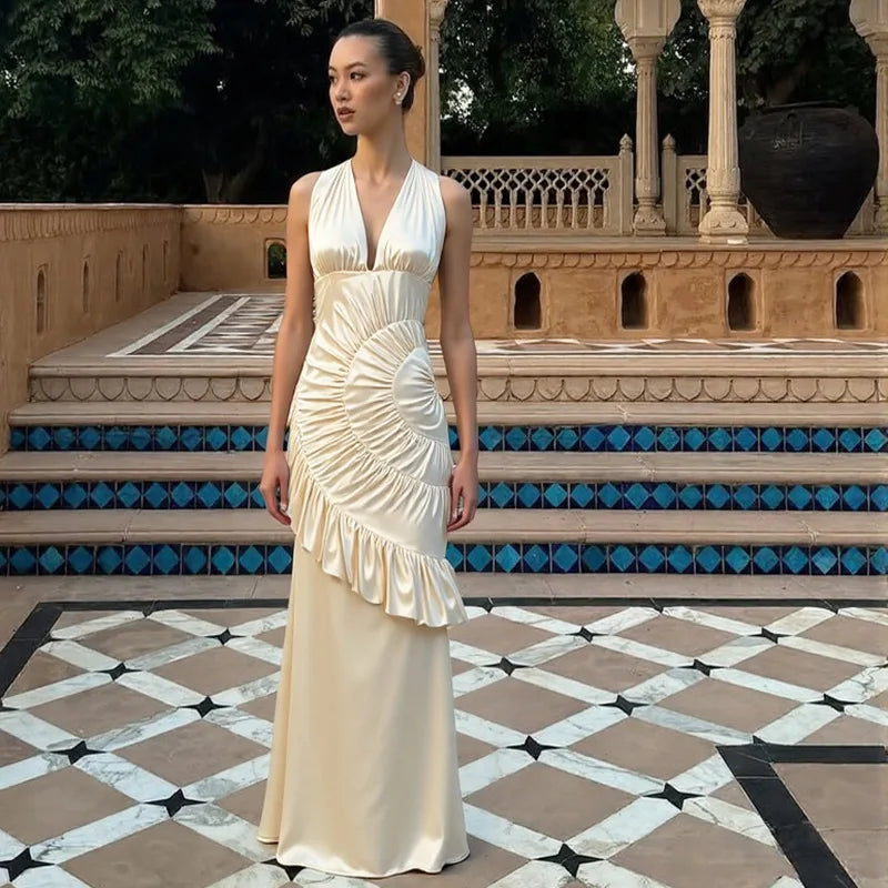 Cinematic outfit styling of a satin neck-mounted maxi dress designed for premium celebrations and elevated photography.