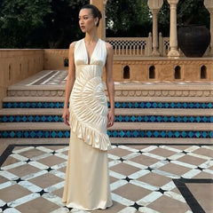 Cinematic outfit styling of a satin neck-mounted maxi dress designed for premium celebrations and elevated photography.