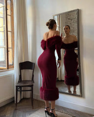 Natural lifestyle image of an off-shoulder midi dress styled indoors with soft posture, minimal lighting, and textured faux fur accents.