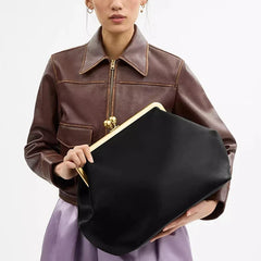 Sculptural shell clutch with folded silhouette and clean PU finish
