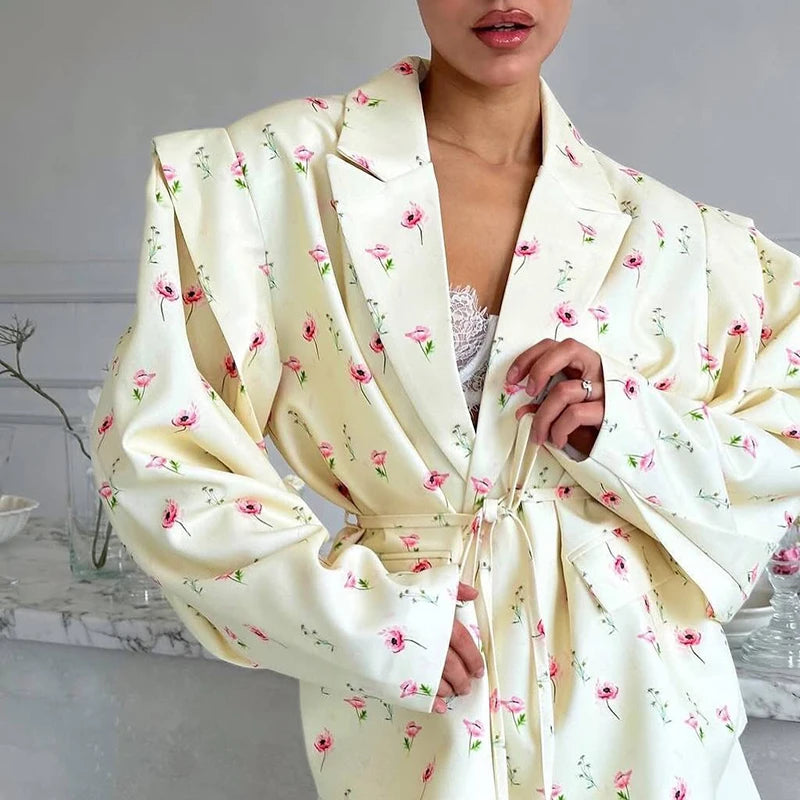 Close-up of pastel floral print and tie-belt waist on blazer