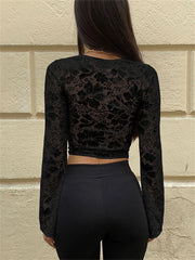 Y2K-style black crop top with mesh sleeves and body-hugging fit