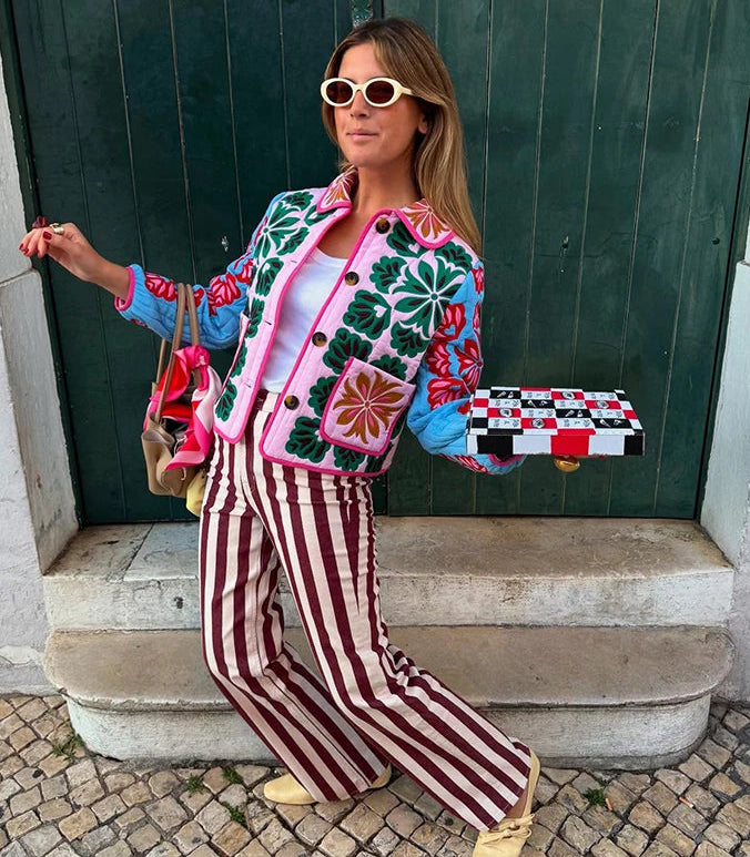 Statement quilted outerwear for women styled in front of a red door