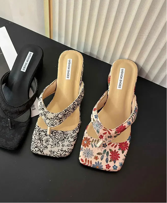 Three pairs of comfort party outdoor floral slippers for relaxed garden evenings on a black surface with a blurred magazine in the background.