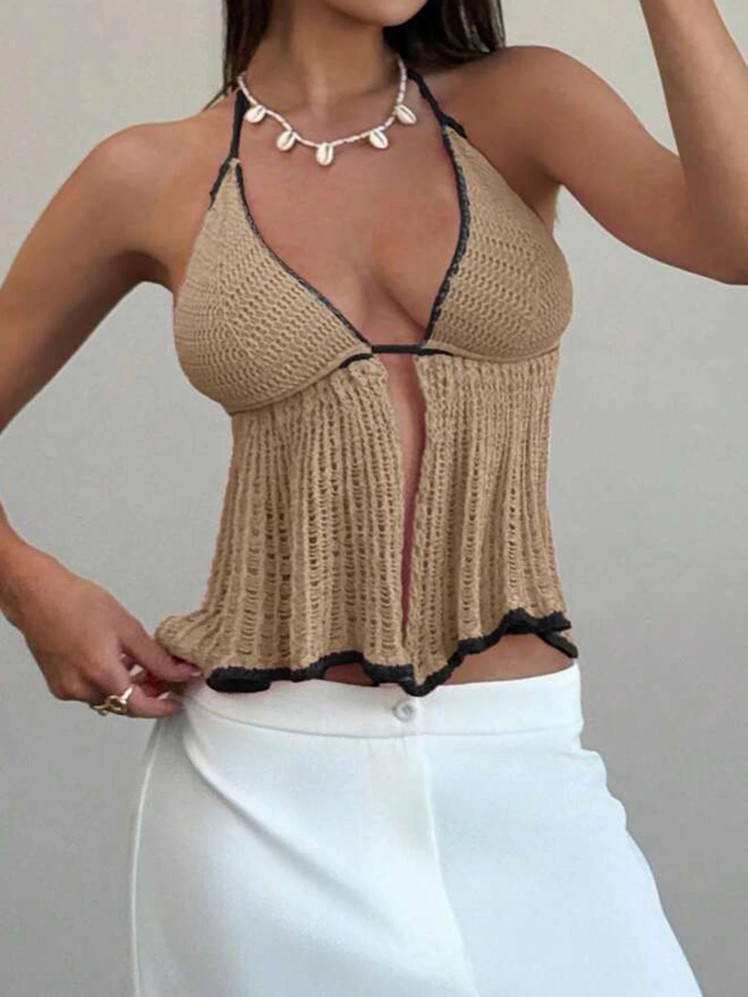 A close-up of the contrast trim and halterneck detail of the top.