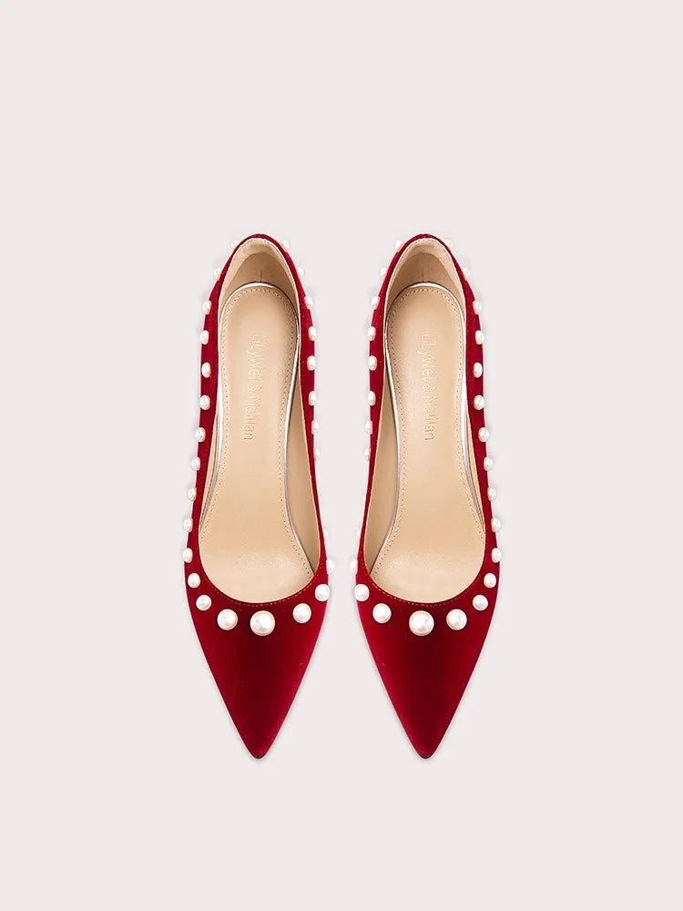 Corduroy pointed stiletto heels in red with elegant pearl detailing