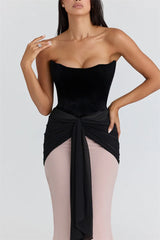 Close-up of the corset tie feature showcasing the textured velvet bodice and polished centre drape.