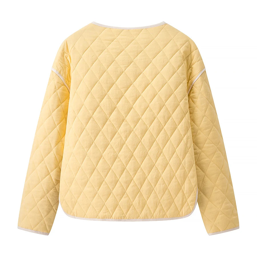 Cozy autumn layer yellow quilted jacket paired with neutral trousers