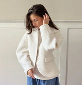 A close-up of the soft faux fur fabric and the open-stitch design.