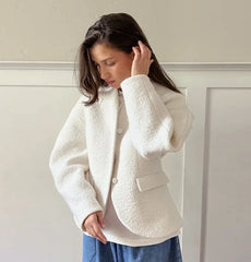 A close-up of the soft faux fur fabric and the open-stitch design.