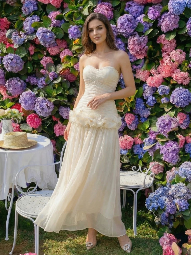 Close-up of the strapless folded bodice with soft ruffle detailing, highlighting the textured layers and smooth fit through the waist.