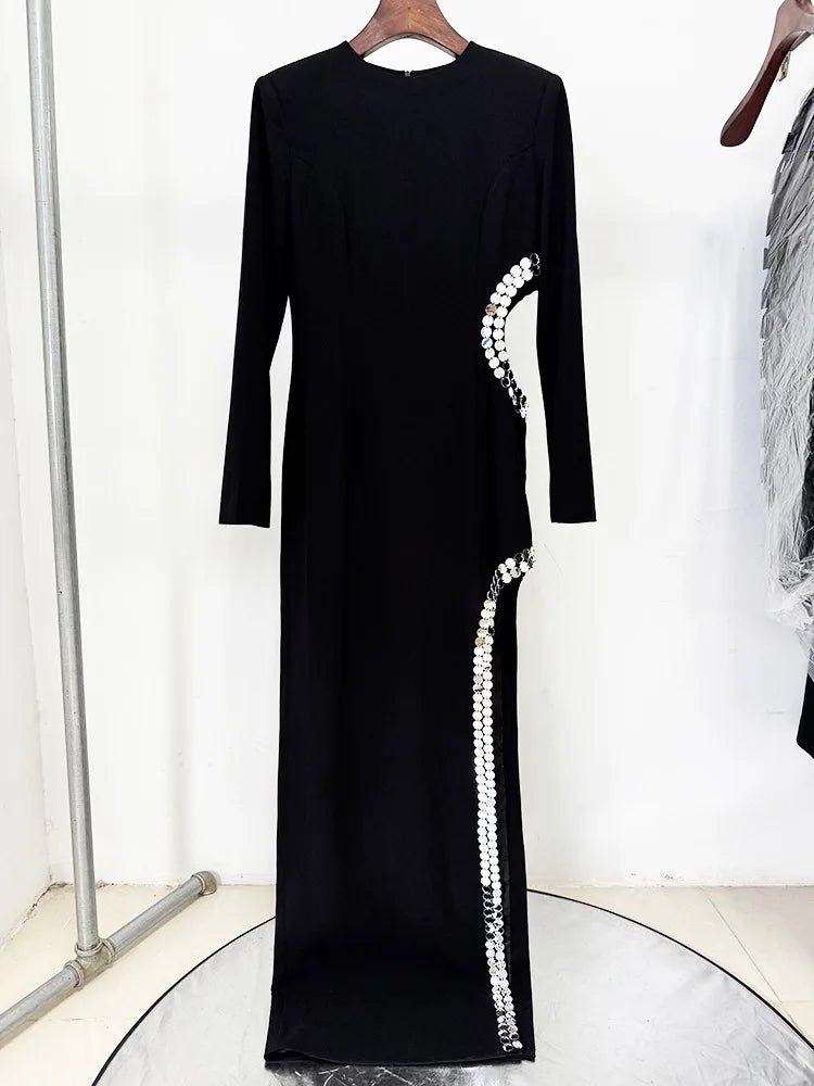 Formal evening gown with beaded slit framing and sleek long sleeves