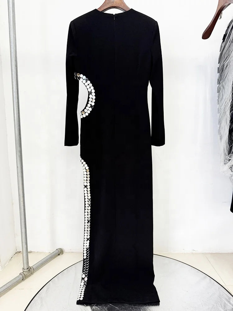 Formal evening gown with beaded slit framing and sleek long sleeves