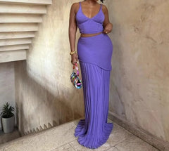 V-neck sleeveless crop top paired with high-waisted purple skirt