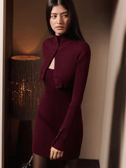 Side profile of a fitted ribbed mini dress paired with a cropped cardigan showing slim shaping and soft knit drape.