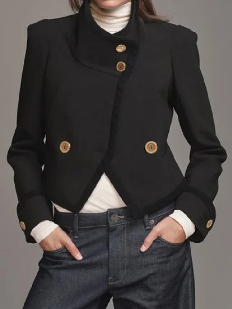 Close view of the jacket’s gold-tone buttons and stand collar, highlighting the structured fabric and clean front finish.