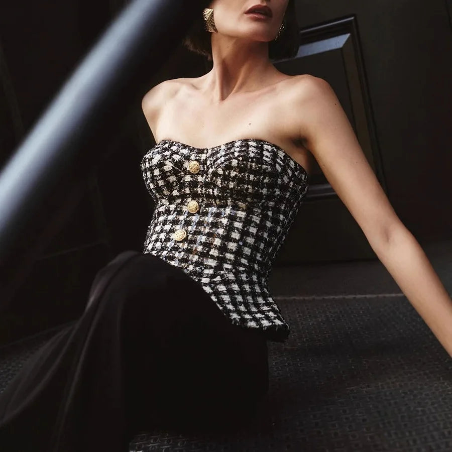 Angled styling shot showing the corset’s cropped waist definition and peplum-like flare at the hem for a sculpted silhouette.