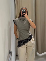 A fitted sleeveless stand-collar top styled for refined summer or indoor daytime wear.