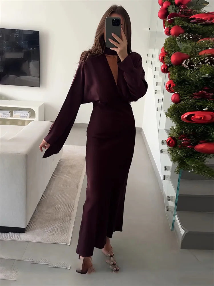 Deep burgundy V-neck satin long dress styled with heels indoors