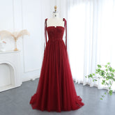 Floor-length A-line tulle gown with beaded bodice on a mannequin
