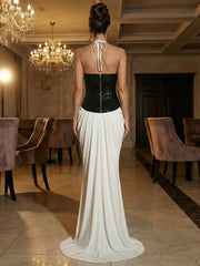 Back view of a slim sheath halter dress with a deep V neckline